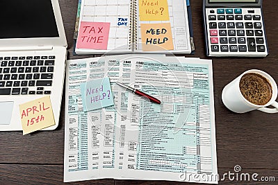 Financial time tax form with laptop and calculator. Office paperwork Editorial Stock Photo
