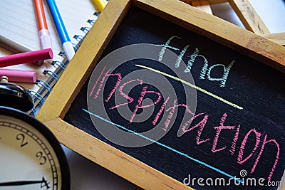 Find inspiration on phrase colorful handwritten on chalkboard, alarm clock with motivation and education concepts. Stock Photo