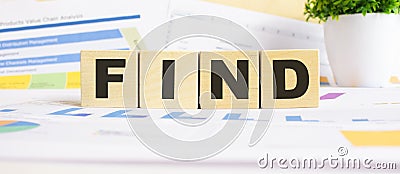 FIND word on wooden cubes. The background is a business graphs. Business and finance concept Stock Photo