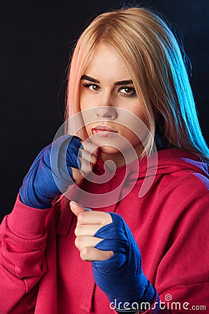 Finding harmony between elegance, femininity and fighting. Kickboxer girl. Stock Photo