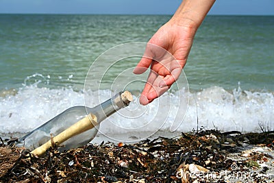 Finding a message in a bottle Stock Photo