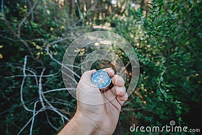 Finding our way in nature with a compass, looking for the right direction Stock Photo