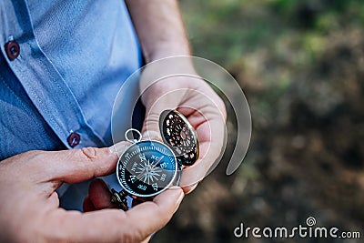 Finding our way in nature with a compass, looking for the right direction Stock Photo