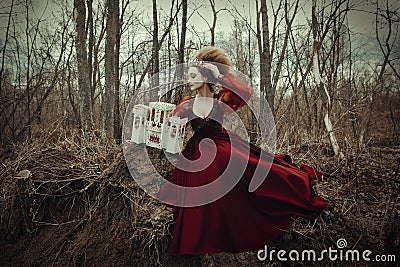 Young girl is posing in a red dress with creative hairstyle Stock Photo
