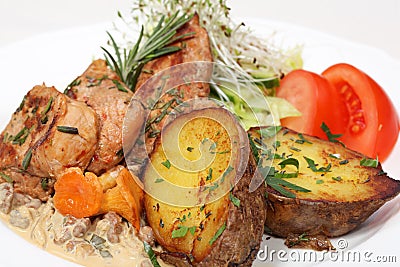 Fine dining meal, chicken and baked potatoes Stock Photo