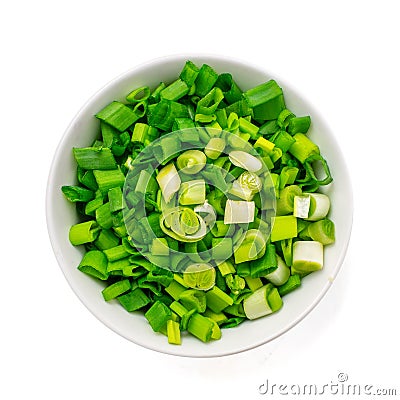 Finely chopped fresh green onions in a generic ceramic bowl isolated on white. Top view Stock Photo