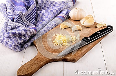 Finely chopped garlic on a wooden board Stock Photo
