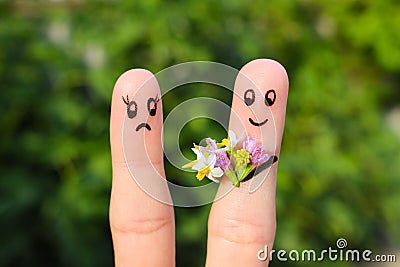 Finger art of couple. man gives woman flowers, she is not satisfied. Stock Photo