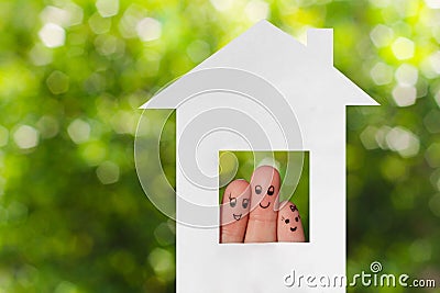 Finger art of a family. Family looking out of the window of the house out of paper Stock Photo