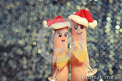 Finger art of a Happy couple. Couple making good cheer in the new year hats. Two glasses of champagne. Stock Photo