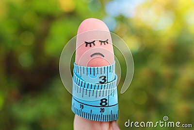 Finger art of lonely woman with meter. Concept she is fat Stock Photo