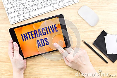 Finger click screen with Interactive ads word with keyboard on w Stock Photo