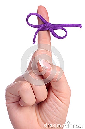 A finger contains a bow-tied string as a reminder Stock Photo