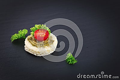 Finger food for party Homemade Canape pesto sauce on top tomato and parsley leaf Stock Photo