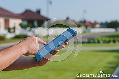 Finger in front of the Tablet on the background of the house Stock Photo