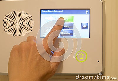 Finger on house security alarm Stock Photo