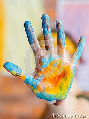 Finger painting art trend blue yellow colored hand Stock Photo