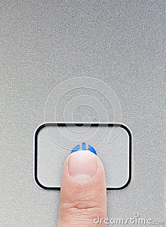 Finger presses silver power button Stock Photo