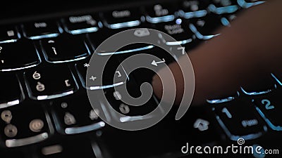 Finger pressing an enter key. Computer user hitting the enter key, up close. Confirmation, sending a message Stock Photo