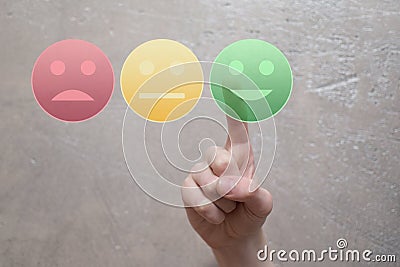 Finger pressing green happy face button Stock Photo