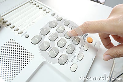Finger pressing key on phone Stock Photo