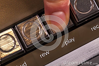 Finger pressing retro play button on vintage music player Stock Photo