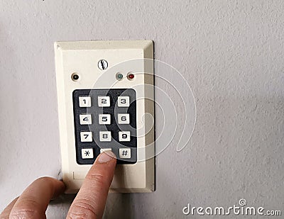 A finger pressing security code, keywords or passwords on a numeric keypad Stock Photo