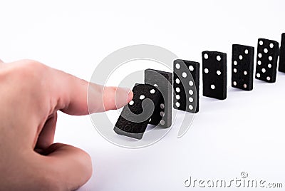 Unleashing the Domino Effect: A Chain Reaction in Motion Stock Photo
