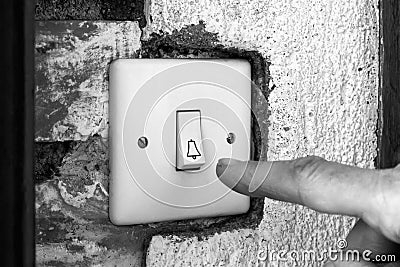 Finger ringing a door bell Stock Photo