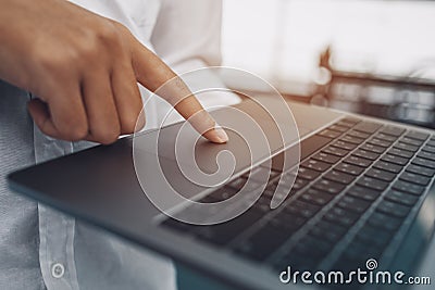 Finger`s businessman use trackpad on laptop Stock Photo