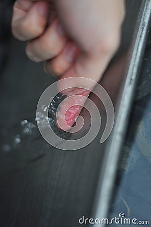 Finger on Steel Stock Photo