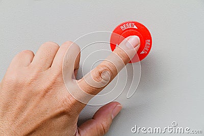 Finger touch on red emergency stop switch and reset Stock Photo