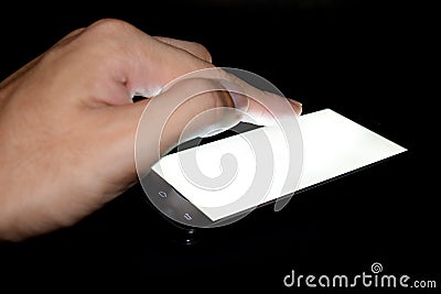 Finger touch white screen Mobile telephone In the darkroom Stock Photo