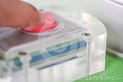 Finger touches on the fingerprint scanner Stock Photo