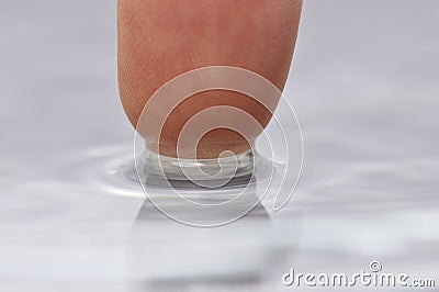 Finger touching water Stock Photo