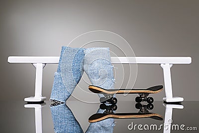 Fingerboard, jeans and white metal railing for riding small skateboards Stock Photo