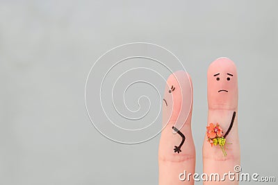 Fingers art of couple. Man gives a woman a bouquet of flowers, she is not satisfied. Stock Photo