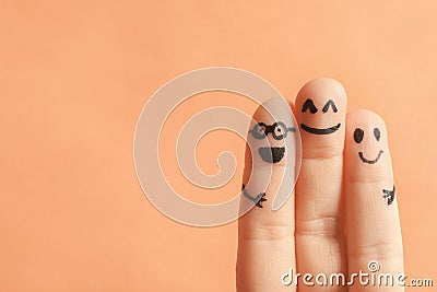 Fingers with drawings of happy faces Stock Photo