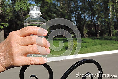 fingers of an elderly woman sore joints rheumatoid arthritis, holding a water bottle , Stock Photo