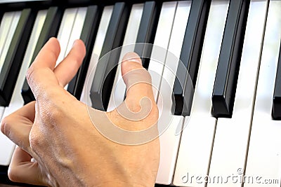 Fingers play chords on piano keys playing synthesizer pianist music hobby Stock Photo