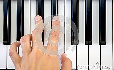 Fingers play chords on piano keys playing synthesizer pianist music hobby top view Stock Photo