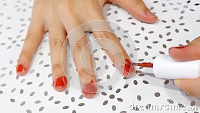 Fingers with red nail polish messily painted. Stock Photo