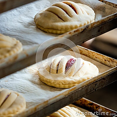 Finished production cookie in factory in the steel table. Production of biscuits, closeup. Working process. Private bakery. Stock Photo