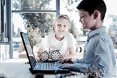 Relaxed children programming their robotic vehicle Stock Photo