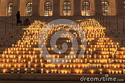 Finland, Helsinki. March 5, 2021. People light candles in front of the parliament building. Also, candles were lit all Editorial Stock Photo