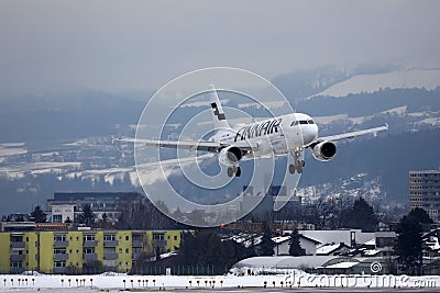 Finnair jet landing on Innsbruck Airport INN, snow in winter Editorial Stock Photo