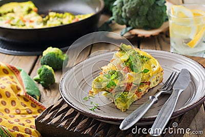 Finnis, omelet with broccoli, farel, potatoes and onions. Rustic style. Stock Photo