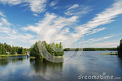 Finnish lake with green islands under summer sky. Stock Photo