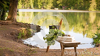 Finnish summer landscape and sauna objects on bench by lake. Stock Photo