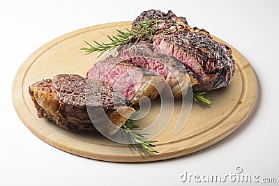 Fiorentina T-bone steak cut on round wooden chopping board Stock Photo